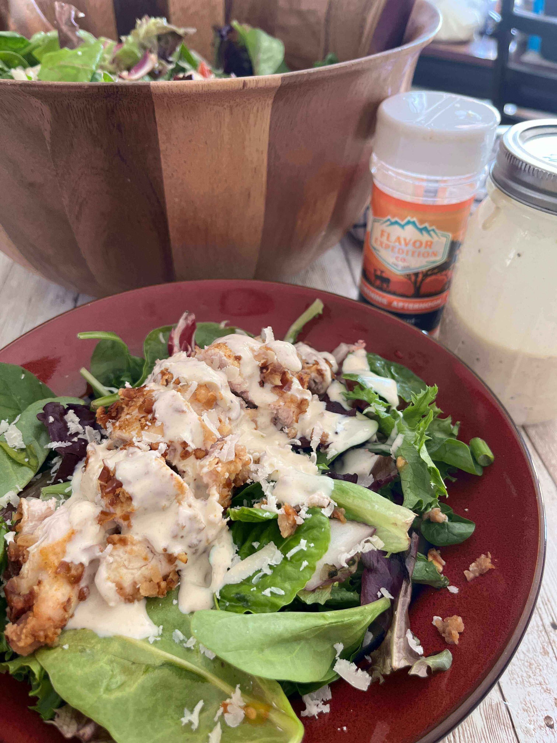 Delicious Spicy Mustard Pretzel Chicken Salad topped with creamy dressing, served on a vibrant plate.