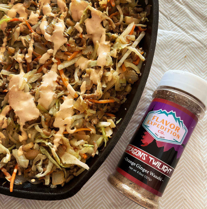 Fire-Breathing Egg Roll in a Bowl topped with sauce next to Dragons Twilight Orange Ginger Wasabi seasoning.