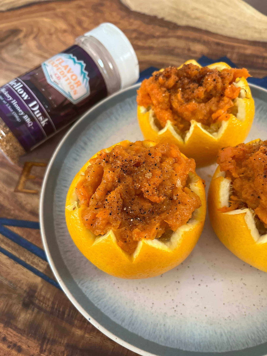 Smoky Sweet Potato in Citrus Cups topped with Mellow Dusk seasoning in a bowl on a wooden surface