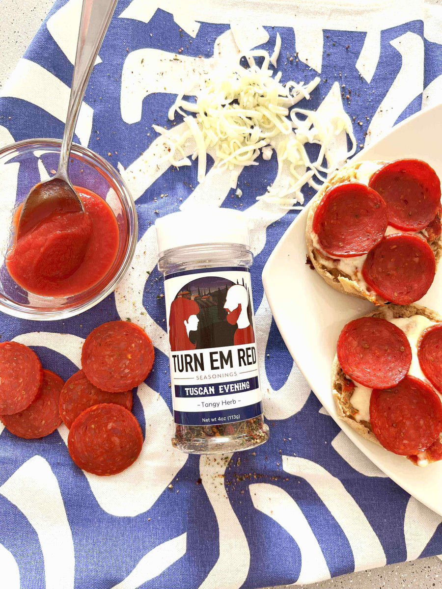 Mini Pizzas, Big Flavor: Quick English Muffin Pizzas with pepperoni and seasoning on a colorful tablecloth.