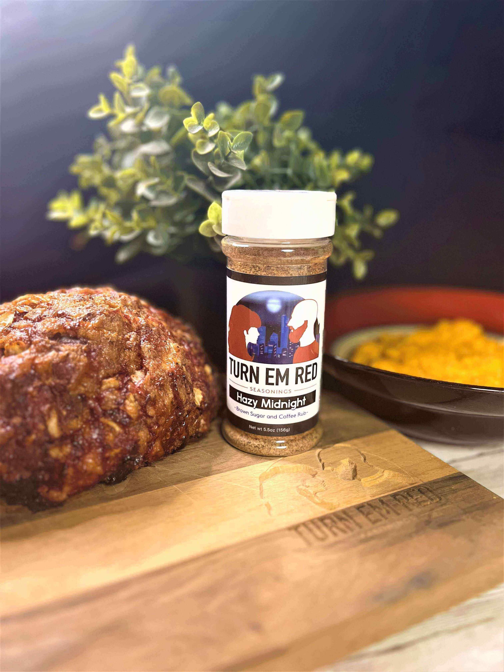 BBQ After Dark: Hazy Midnight Meatloaf with a spice jar and side dish on a rustic wooden board.
