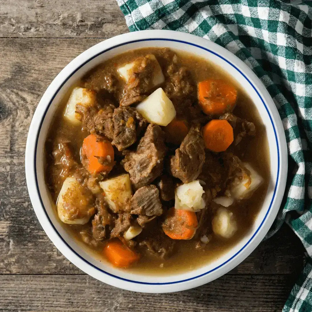 Stout-Soaked & Midnight Rubbed: Guinness Irish Stew filled with beef, carrots, and potatoes in a bowl.