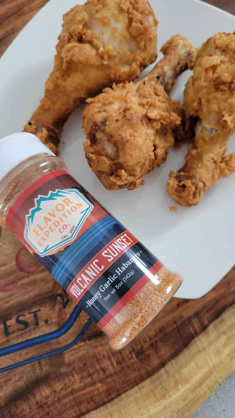 Crispy Volcanic Sunset Fried Chicken (Hot Honey Garlic Habanero Style) served with seasoning.