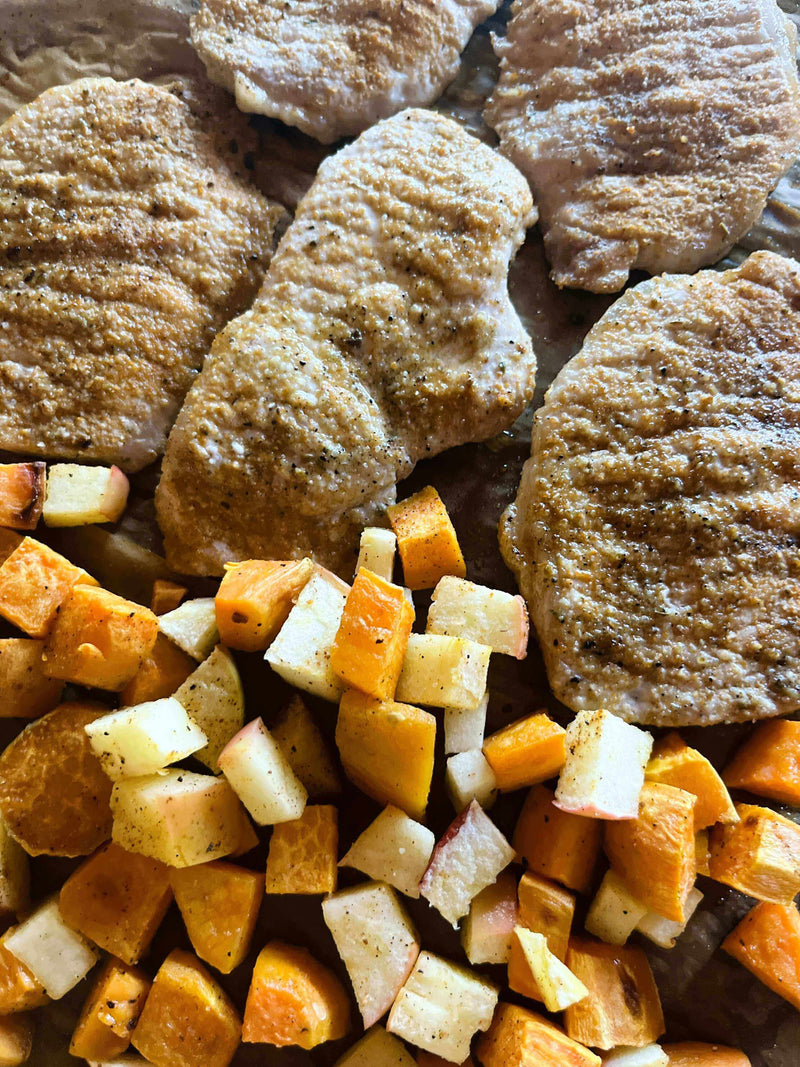 Spicy Sizzlin Sheet Pan Pork Chops garnished with sweet potatoes and apples, ready for a bold and quick dinner.