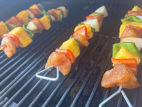 Sweet & Smoky Chicken Kebobs grilling on a barbecue, showcasing vibrant veggies and juicy chicken pieces.