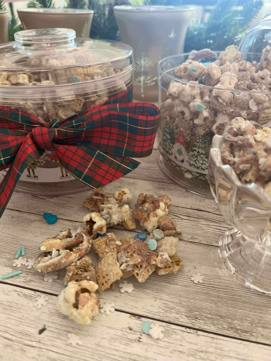Reindeer Chow: The Sweet Snack Santa Actually Wants This Year in festive jars with a plaid ribbon.