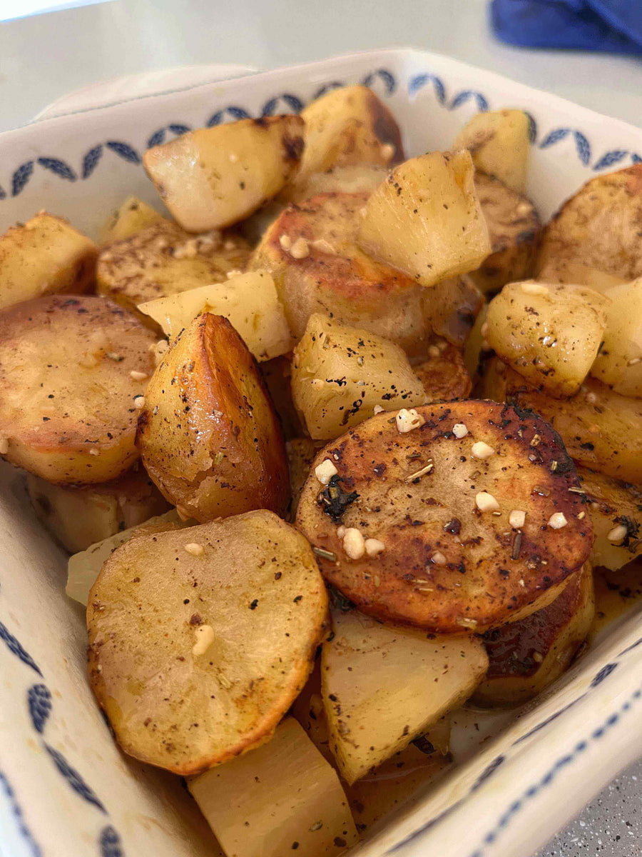 Melting Pineapple Potatoes in a bowl, featuring golden roasted potatoes and sweet pineapple pieces.
