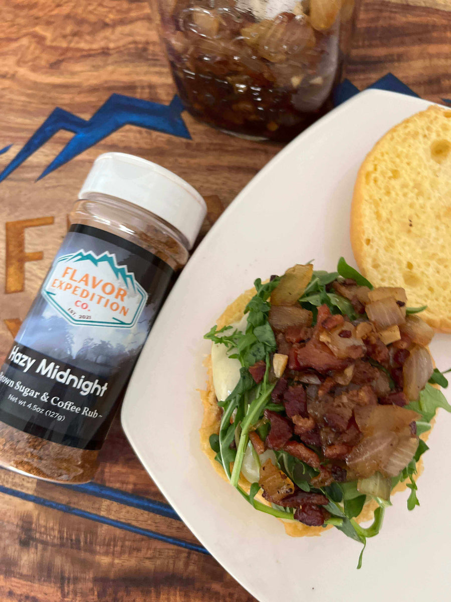 Midnight Ride Blueberry Bison Burger topped with Hazy Midnight spice mix, featuring bacon, greens, and crispy onions.