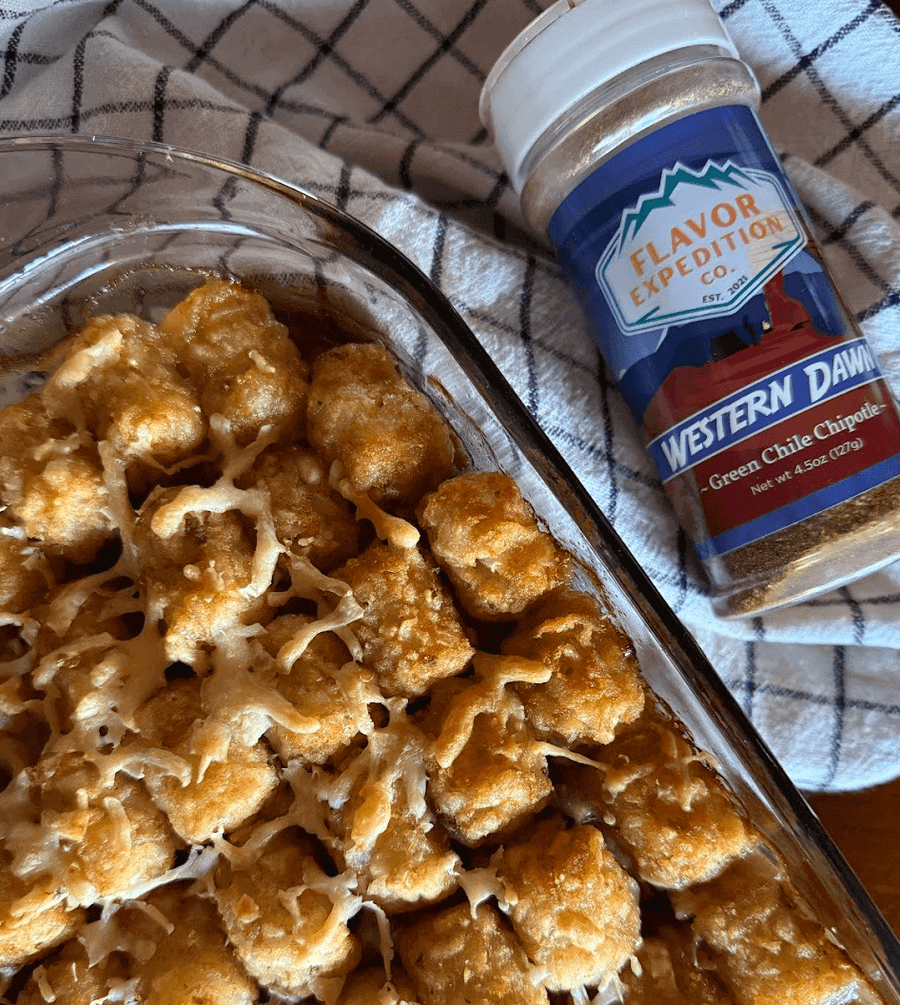 Delicious Sunset Tot Bake casserole topped with cheese and served with Flavor Expedition's Western Dawn seasoning.