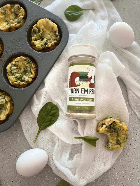 Sunrise Spinach Egg Muffins on a countertop with eggs and seasoning, perfect for a healthy breakfast recipe.