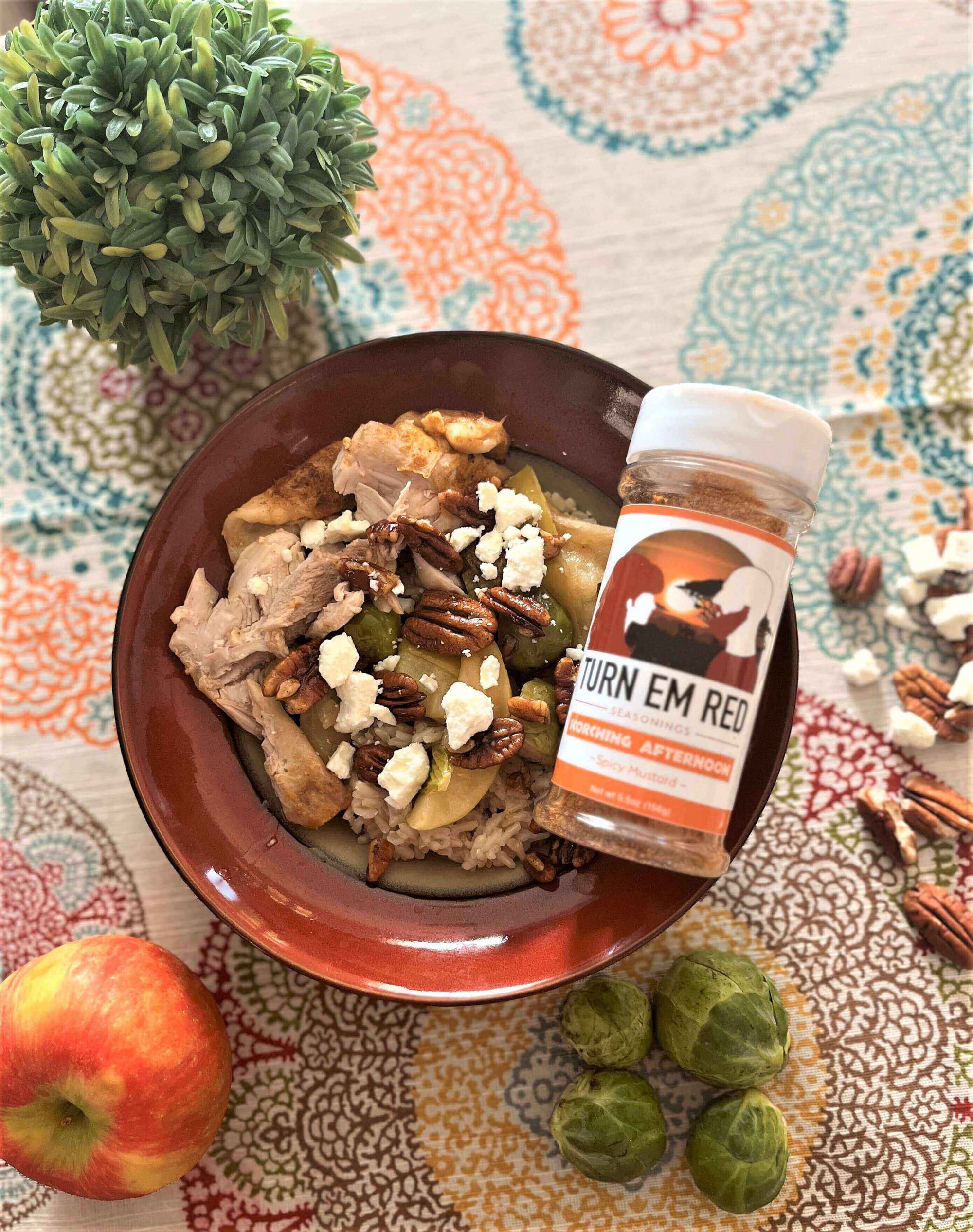 Delicious Fall Harvest Bowl recipe featuring chicken, pecans, and fresh veggies on a colorful tablecloth.