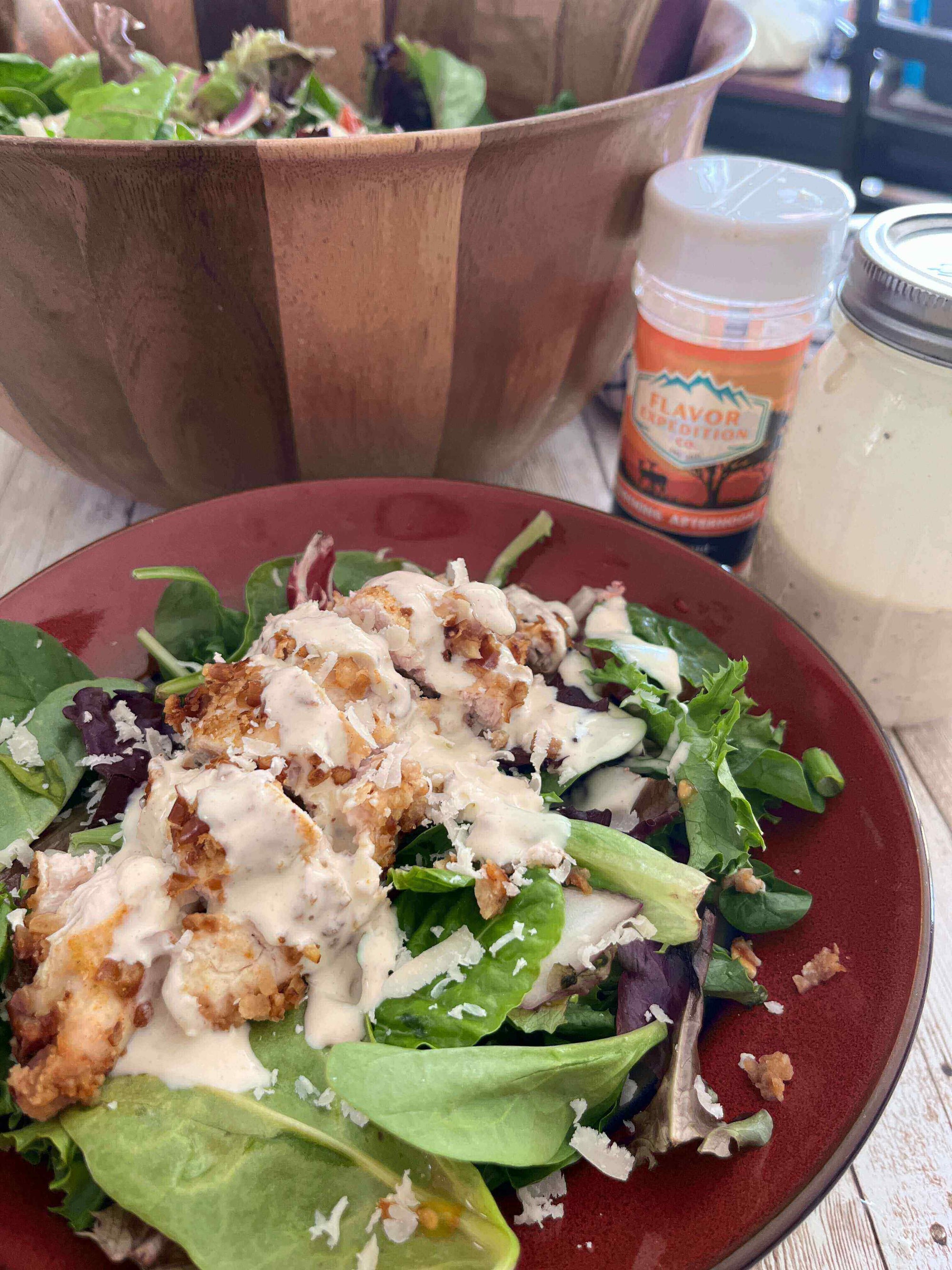 Delicious Spicy Mustard Pretzel Chicken Salad topped with creamy dressing and served in a vibrant bowl.