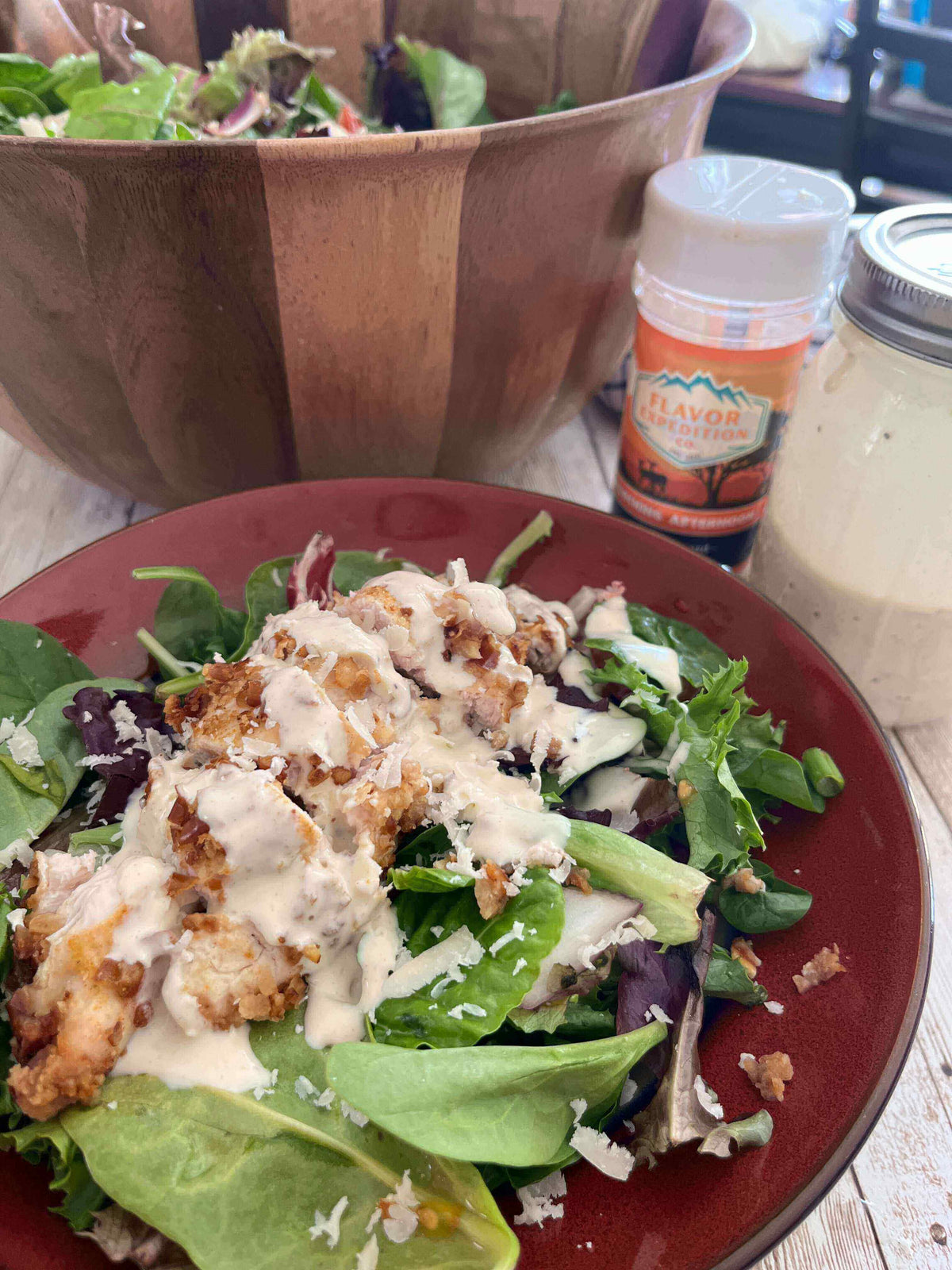Delicious Spicy Mustard Pretzel Chicken Salad topped with creamy dressing, served on a vibrant plate.
