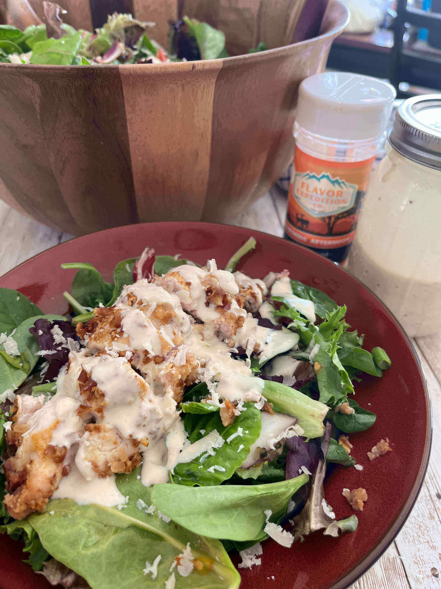 Delicious Spicy Mustard Pretzel Chicken Salad topped with creamy dressing, served on a vibrant plate.