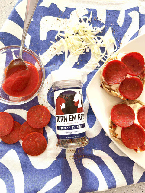 Mini Pizzas, Big Flavor: Quick English Muffin Pizzas with pepperoni and seasoning on a colorful tablecloth.
