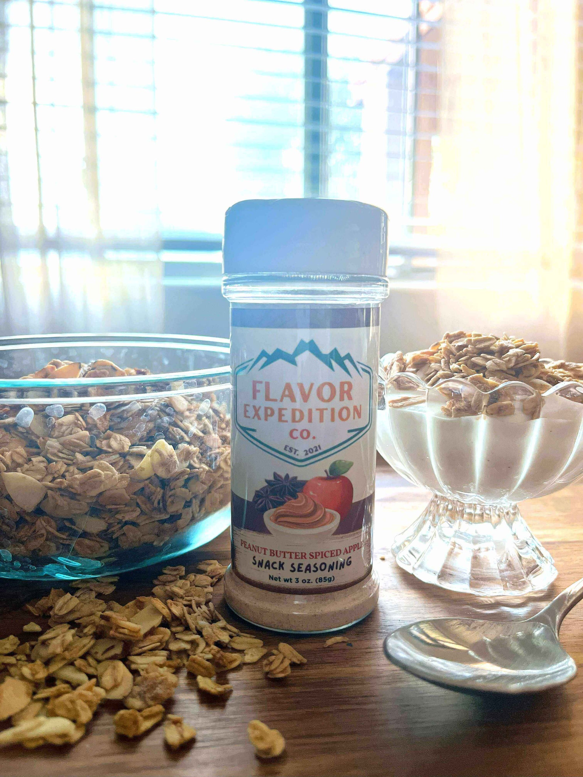 Peanut Butter Spiced Apple Granola with Flavor Expedition seasoning and bowls of granola.