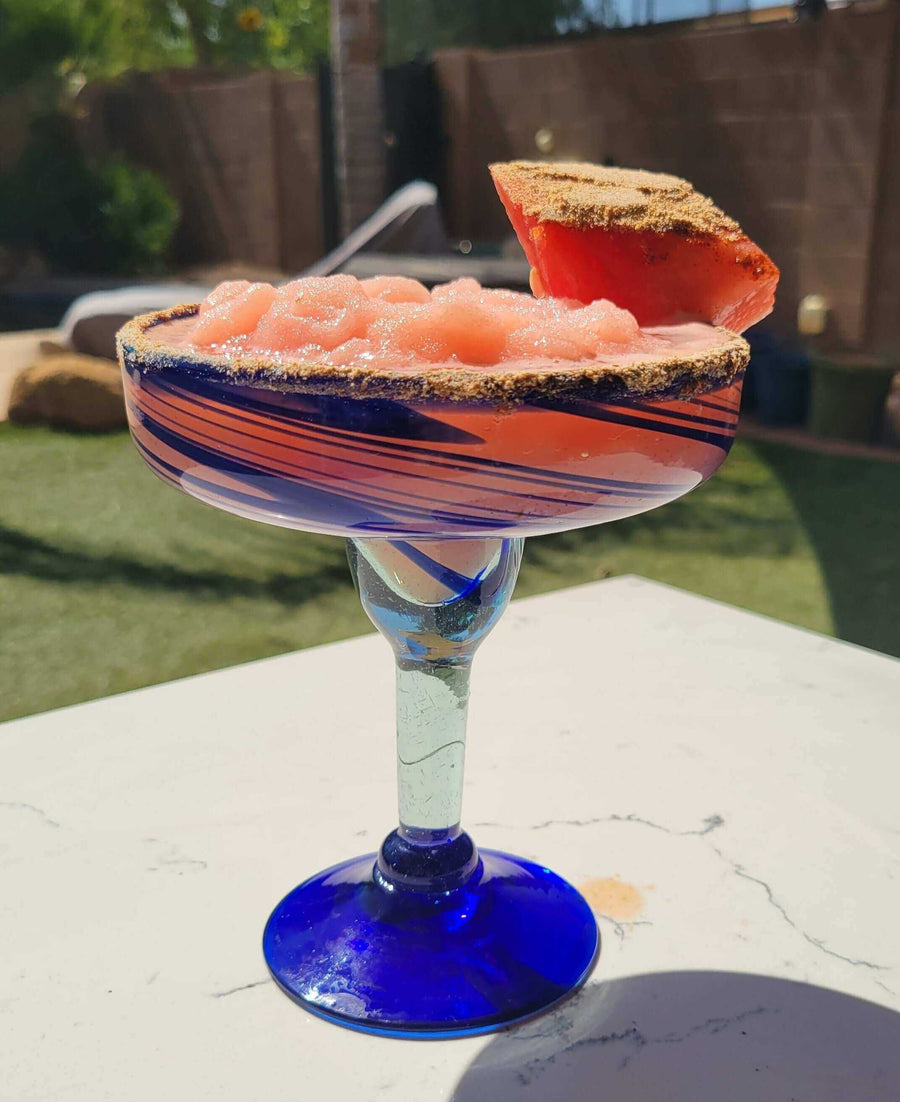 Island Time Margarita (aka Watermelon Vacation in a Glass) served in a colorful margarita glass with a watermelon slice.
