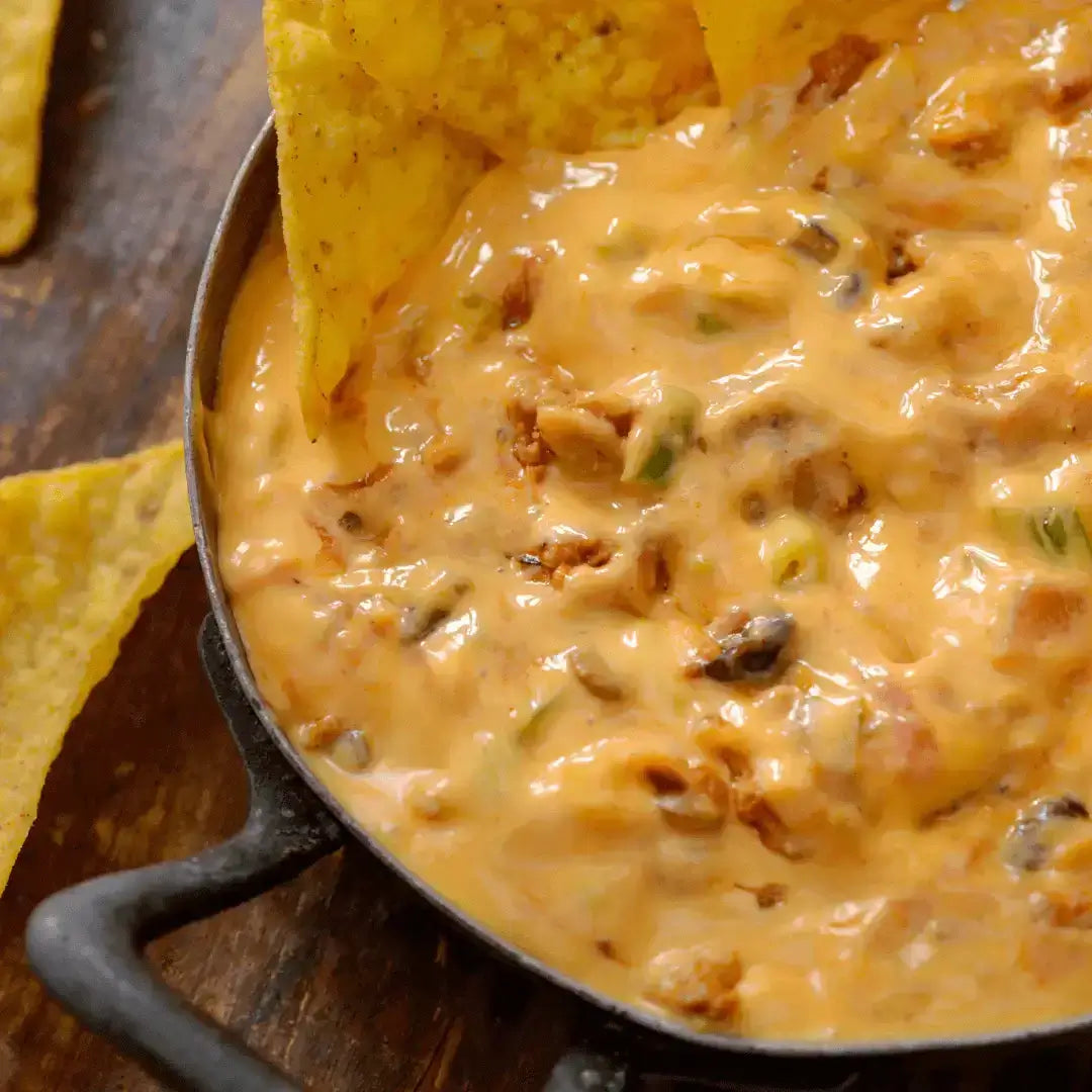Crack Chicken Queso Dip in a skillet surrounded by tortilla chips, creamy and cheesy with a savory finish.
