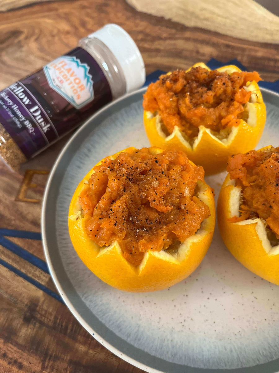 Smoky Sweet Potato in Citrus Cups topped with Mellow Dusk seasoning in a bowl on a wooden surface