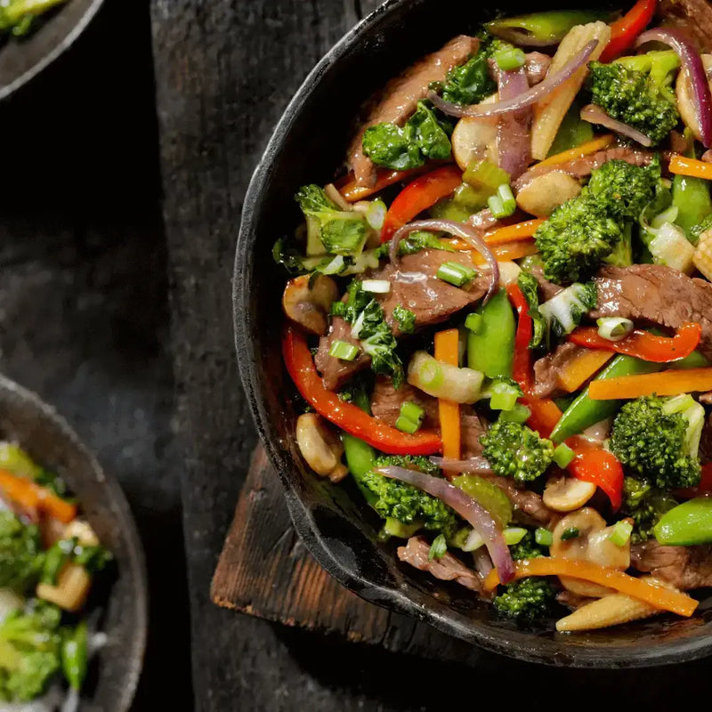 Delicious Midnight Cravings Stir-Fry with colorful veggies and tender steak in a sizzling pan.