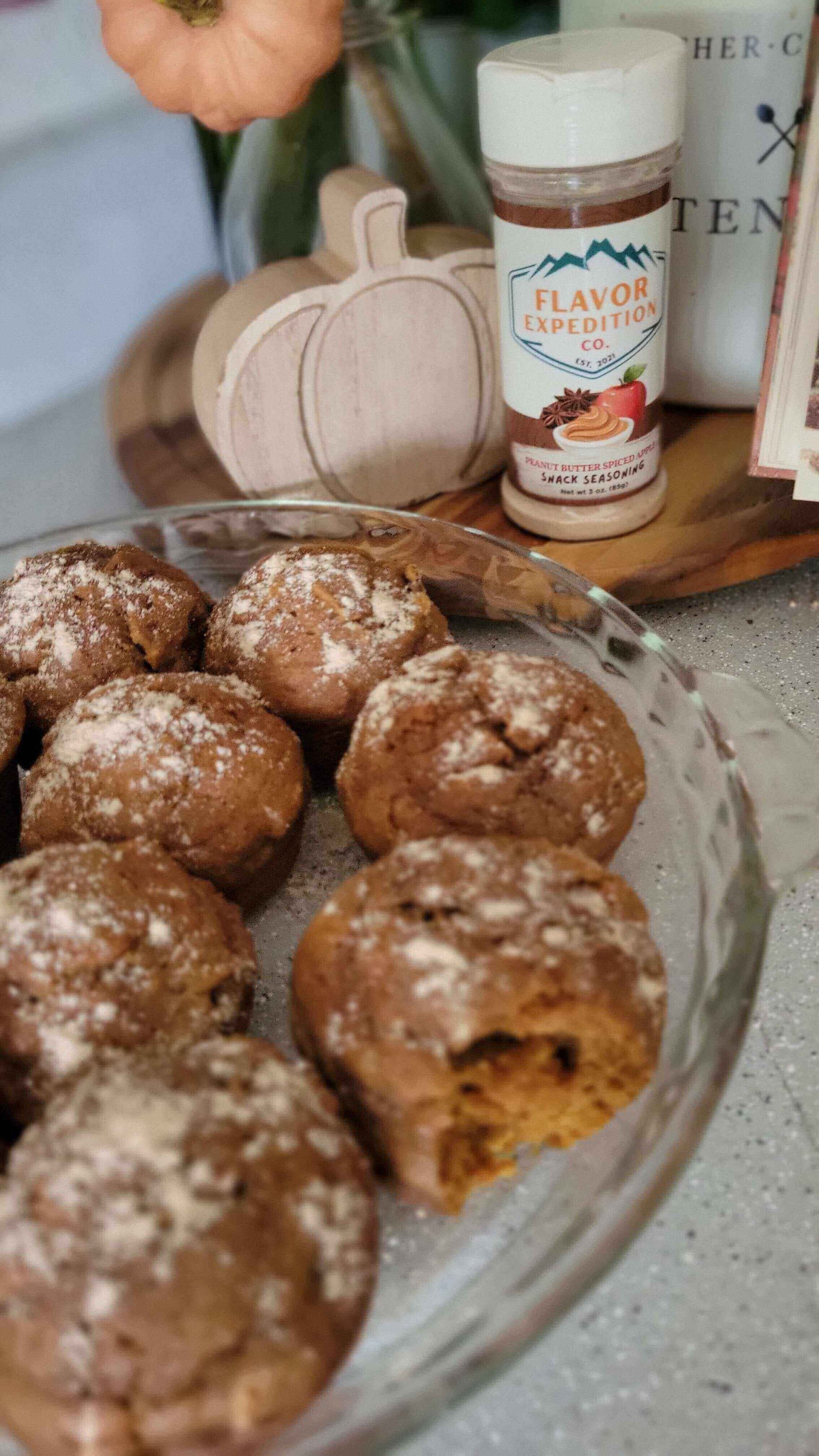 Old Salem Pumpkin Muffins in a glass bowl with Flavor Expedition seasoning and a decorative pumpkin.