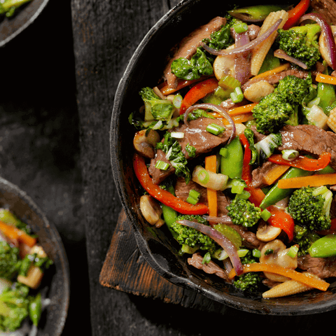 Delicious Midnight Cravings Stir-Fry featuring vibrant vegetables and tender steak in a sizzle-filled pan.