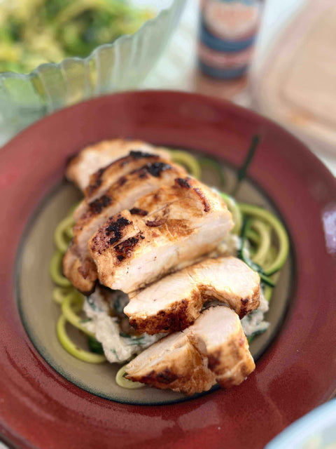 Honey Garlic Habanero Chicken with Lemon Ricotta Zoodles served on a vibrant plate with zoodles and grilled chicken.