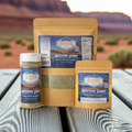 Green Chile Chipotle Seasoning products by Western Dawn displayed with a scenic background.