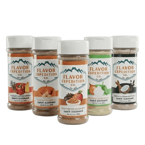 Five bottles of Flavor Expedition Co. snack seasonings on a white background