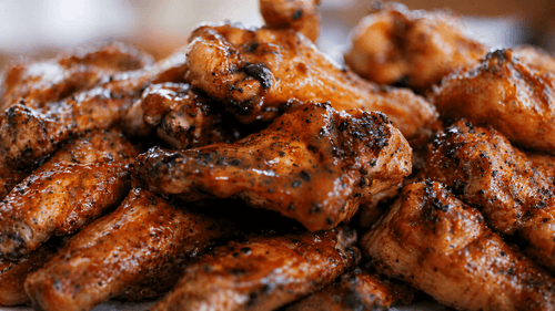 Close-up of crispy fried chicken wings with a blurred background