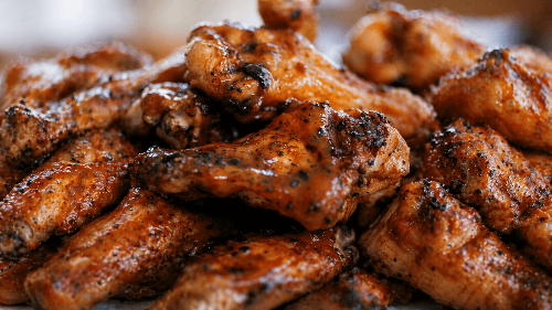Close-up of crispy fried chicken wings with a blurred background