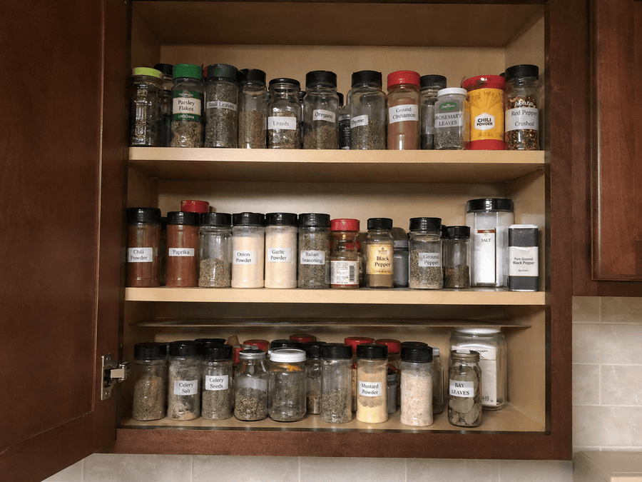 Spice cabinet with labeled jars of spices