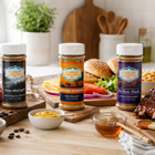 Three jars of 'Flavor Expedition' seasoning on a kitchen counter with food items.