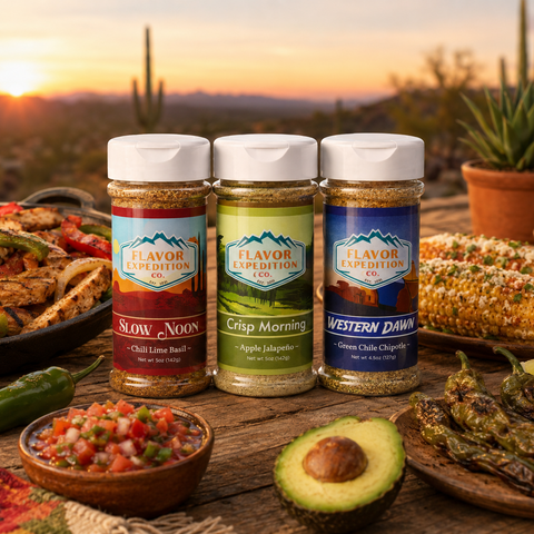 Three jars of Flavor Expedition spices on a wooden table with a desert sunset background.