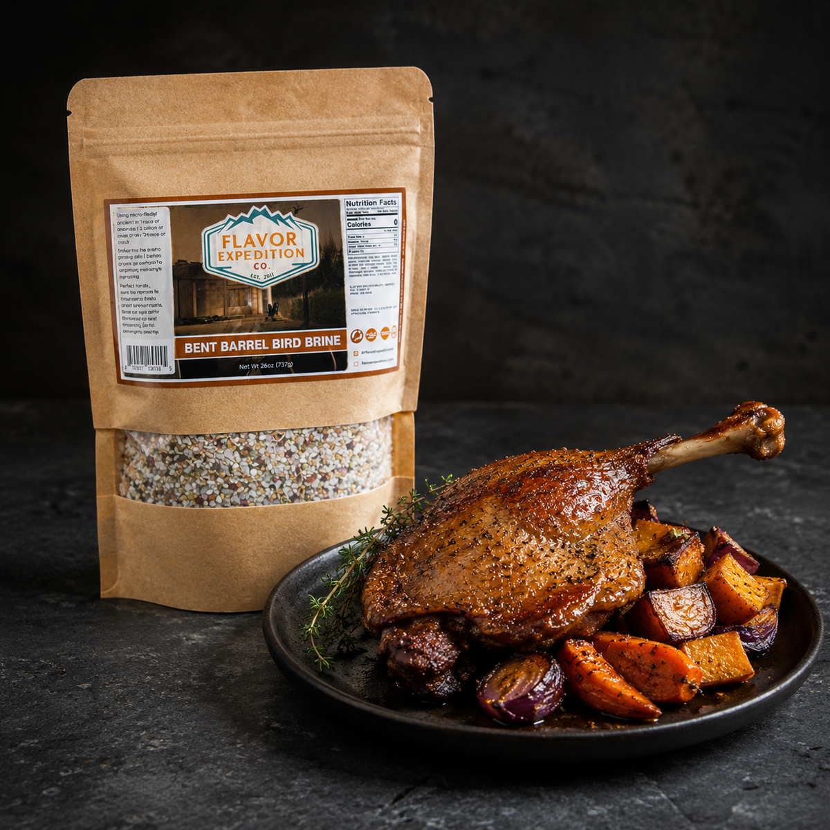 Brown paper pouch of Flavor Expedition Co. Bent Barrel Bird Brine next to a roasted poultry leg and vegetables on a plate.