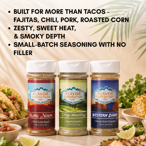 Three seasoning jars with labels on a table with food in the background