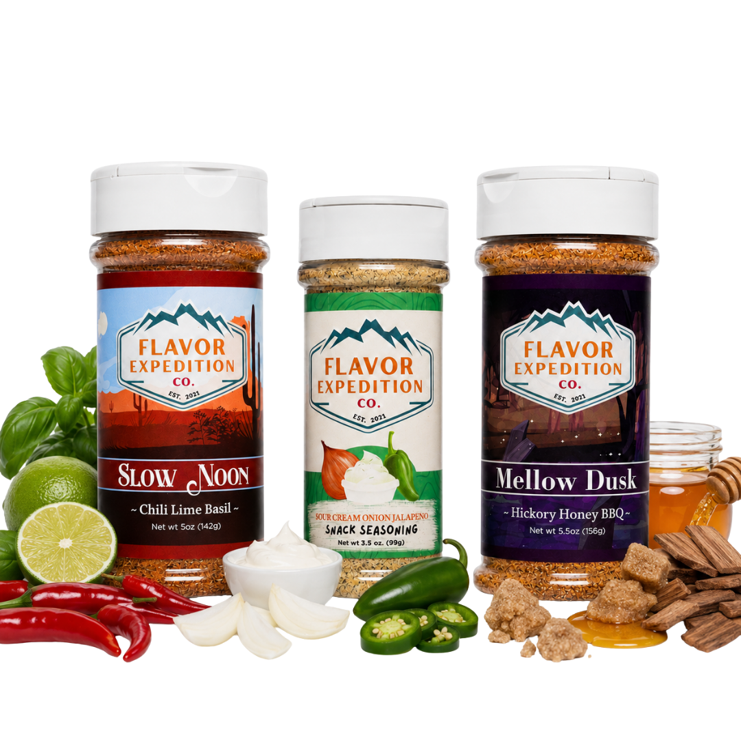 Three spice seasoning bottles from Flavor Expedition Co. are displayed on a white background with their corresponding flavor ingredients arranged around them.