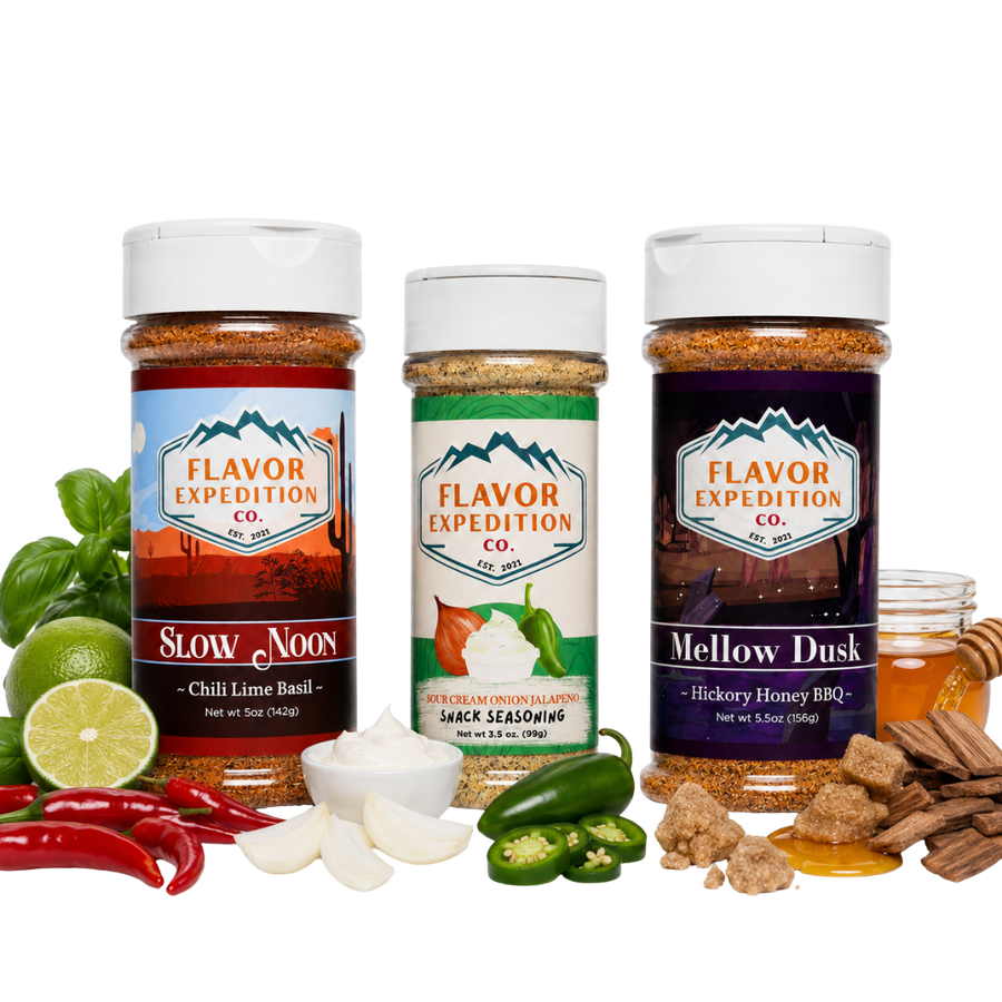 Three spice seasoning bottles from Flavor Expedition Co. are displayed on a white background with their corresponding flavor ingredients arranged around them.