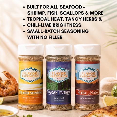 Three seasoning jars with labels 'Island Sunrise', 'Tuscan Evening', and 'Slow Noon' from Flavor Expedition Co. on a table with food.