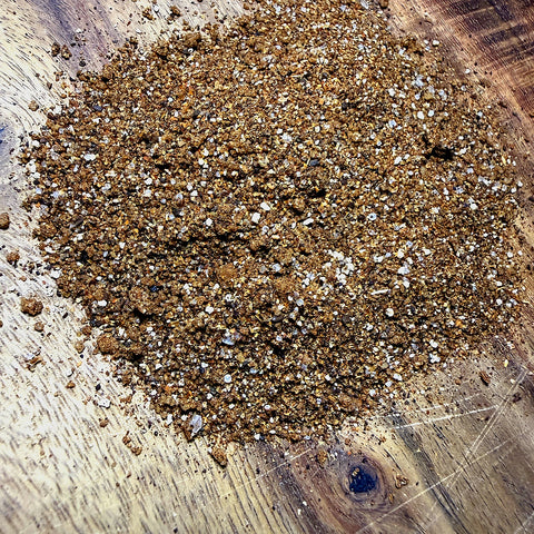 Close-up of a pile of soil on a wooden surface