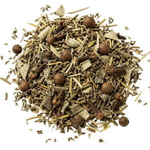 Heap of mixed dried herbs and spices on a white background