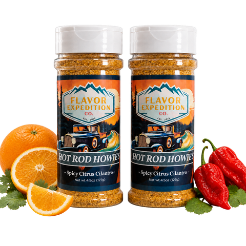 Two jars of 'Hot Rod Howies' spice with oranges and peppers on a white background
