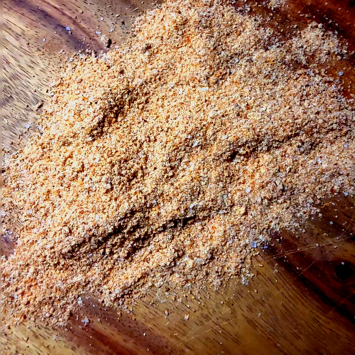 Pineapple Habanero Seasoning spread out on a wooden surface highlighting its unique blend of flavors.