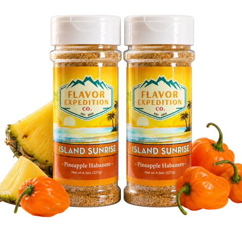 Two bottles of Flavor Expedition Co. Island Sunrise Pineapple Habanero seasoning with pineapples and habanero peppers on a white background.