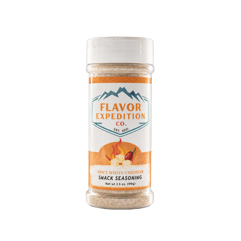 Spicy White Cheddar snack seasoning container with 'Flavor Expedition Co.' label on a white background