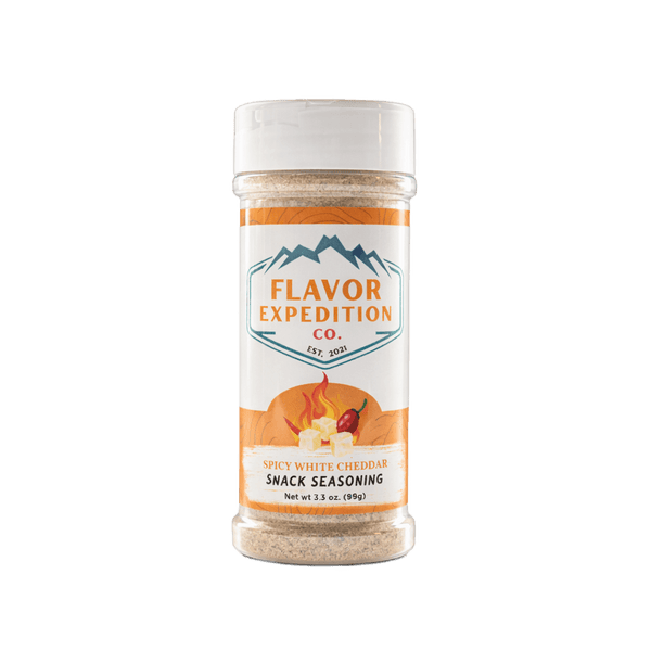 Spicy White Cheddar snack seasoning container with 'Flavor Expedition Co.' label on a white background