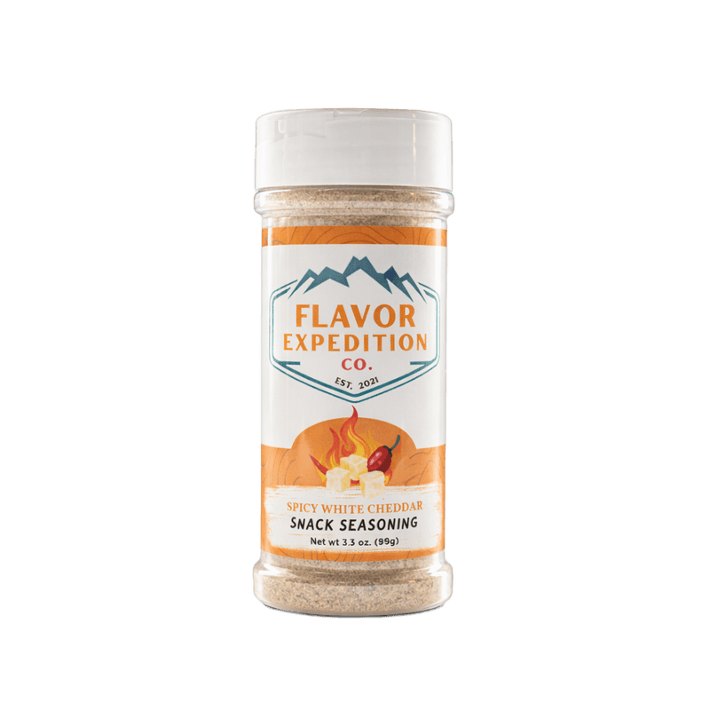 Spicy White Cheddar snack seasoning container with 'Flavor Expedition Co.' label on a white background