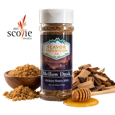 A bottle of Flavor Expedition Co. Mellow Dusk Hickory Honey BBQ seasoning stands centered on a white background, surrounded by ingredients including a wooden bowl of brown sugar, wood chips, and a honey dipper with honey. [pack-1]