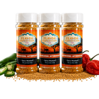 Three bottles of Flavor Expedition Co. Spicy Mustard with peppers and mustard seeds on a black background