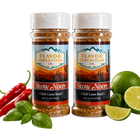 Two jars of Flavor Expedition Co. Slow Noon Chili Lime Basil seasoning with chili peppers, lime, and basil on a white background.